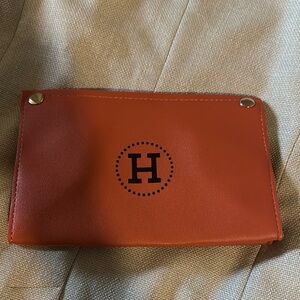 Orange Wallet with Circular Logo and Silver Studs